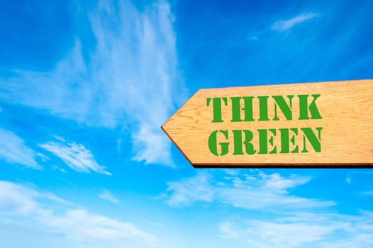 Wood arrow sign against clear blue sky with Think Green, Ecology concept
