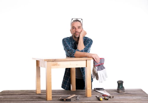 worker in blue plaid shirt repair a table