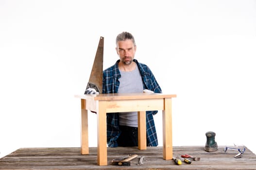 funny worker in blue plaid shirt repair a table