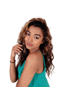A closeup image of a gorgeous young teenager with her long curly .brunette hair, looking over her shoulder, isolated for white background.