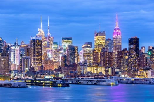 West New York City midtown Manhattan skyline panorama view from Boulevard East Old Glory Park over Hudson River at dusk.