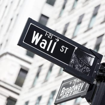 Wall St. street sign in lower Manhattan, New York City, USA.