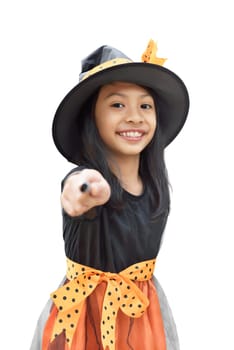 Closeup view of asian child girl with witch costume and magic wand isolated over white background