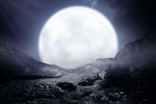 Foggy rocky mountain with moonlight background