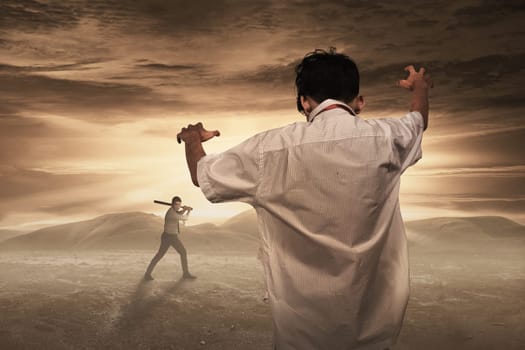 Zombie come to haunt man with baseball bat. Halloween concept
