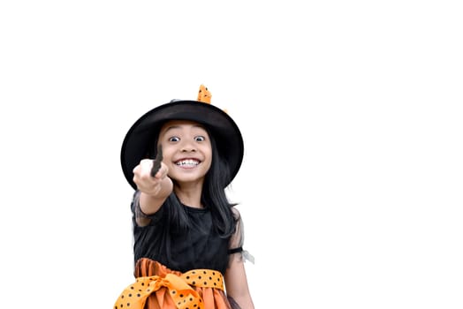 Smiling asian witch girl with magic wand isolated over white background
