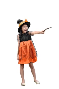 Portrait of asian little witch girl with a magic wand posing isolated over white background