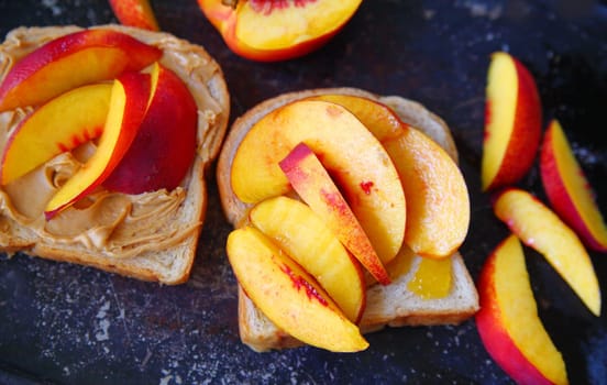 Fresh nectarine slices and peanut butter sandwich from overhead