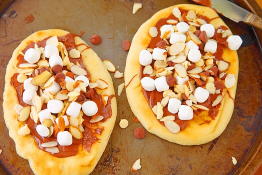 Naan pizzas with marshmallows, chocolate spread and almonds