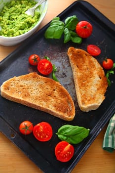 Preparing avocado toast with caprese