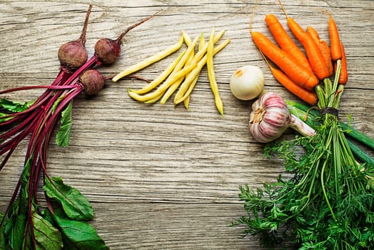Assortment of fresh vegetables and ingredients on wooden rustic background