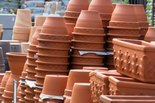 Terracotta pots for sale on shelf in the garden center shop