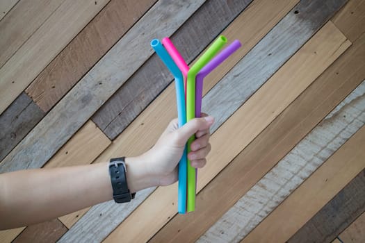 Hand holding silicone drinking straw, stock photo