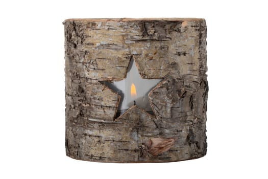 Decorative tea light as a star in wooden tree stump. Christmas time.