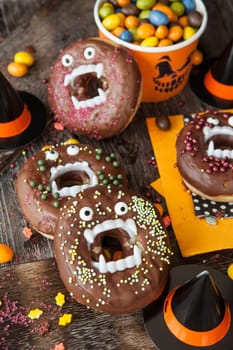 Scary Halloween donuts with chocolate frosting and sugar sprinkles
