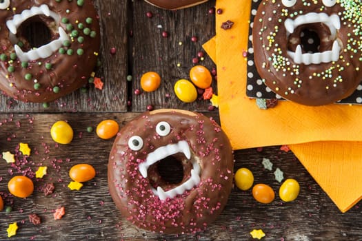 Scary Halloween donuts with chocolate frosting and sugar sprinkles