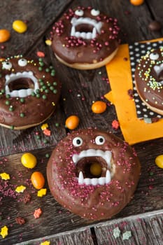 Scary Halloween donuts with chocolate frosting and sugar sprinkles