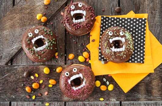 Scary Halloween donuts with chocolate frosting and sugar sprinkles