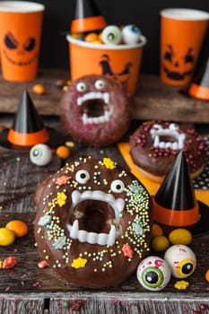 Scary Halloween donuts with chocolate frosting and sugar sprinkles