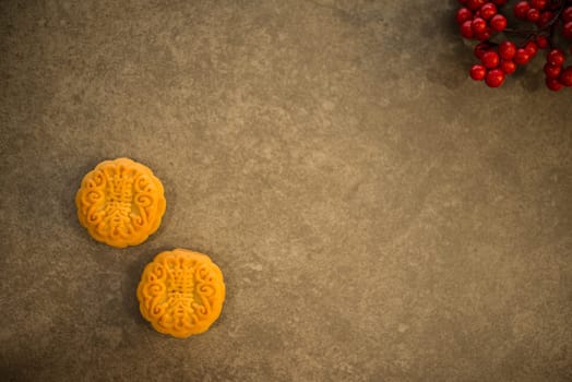 Mooncake is traditional pastry eaten during the Mid-Autumn Festival. Flatlay on table top with copy space. The Chinese character represent "lotus paste""."