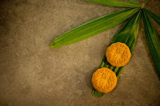 Moon cakes is traditional pastry eaten during the Mid-Autumn Festival. Flatlay on table top with copy space. The Chinese character represent "lotus paste""."