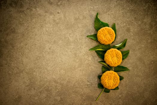 Moon cakes is traditional pastry eaten during the Mid-Autumn Festival. Flatlay on table top low light with copy space. The Chinese character represent "lotus paste""."