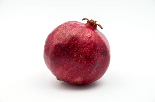 Fruit of a pomegranate of red color on a white background