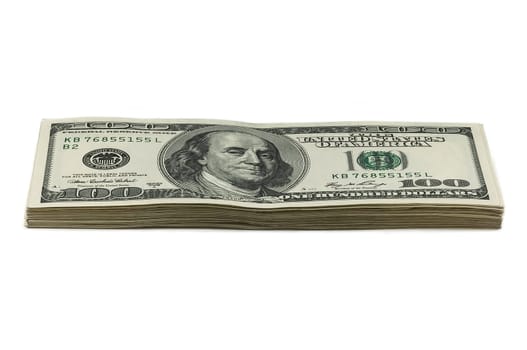 A small stack of one hundred dollar bills on a white background. View at an angle. Isolated.