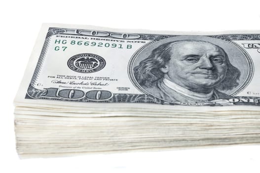 A bundle of ten thousand American dollars in bills of one hundred dollars. Isolated.