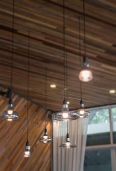 Vintage light bulbs hanging from ceiling, stock photo