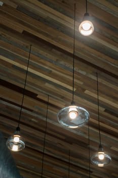 Vintage light bulbs hanging from ceiling, stock photo