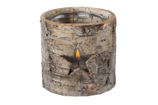 Decorative tea light as a star in wooden tree stump. Christmas time.