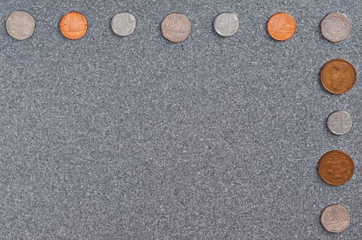 Coins of Great Britain of different dignity against the background of gray granite.