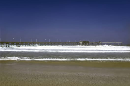 Pier on shore of Pacific Ocean in California
