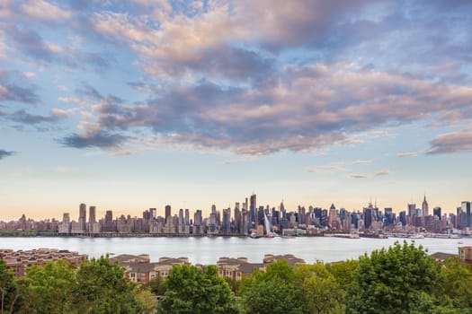 New York City midtown Manhattan skyline panorama view from Boulevard East Old Glory Park over Hudson River.