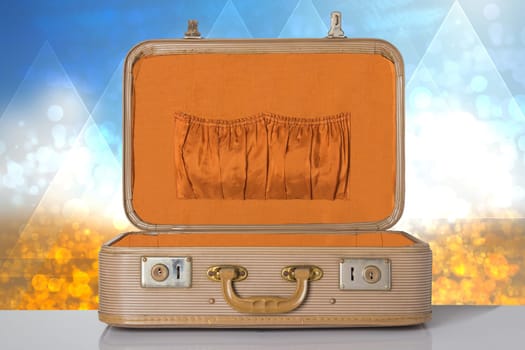 Old vintage suitcase on a table with abstract bright background. Concept travel.