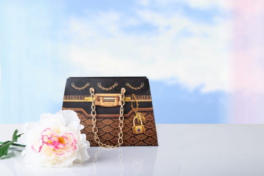 A single colorful artificial summer flower and a gift paper bag with copy space for your product display montage. Pastel background. Mother day, valentine or other holidays.