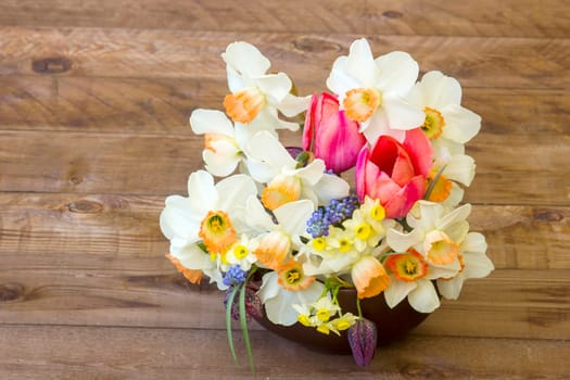 bouquet of spring flowers on wooden background