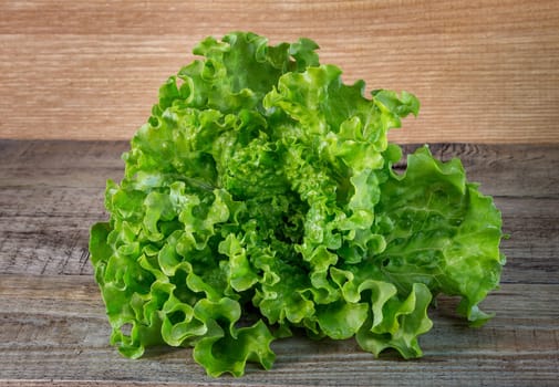 Fresh salad leaves, on a wooden background