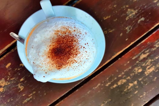 Top view cup of black coffee on a simple wooden table
