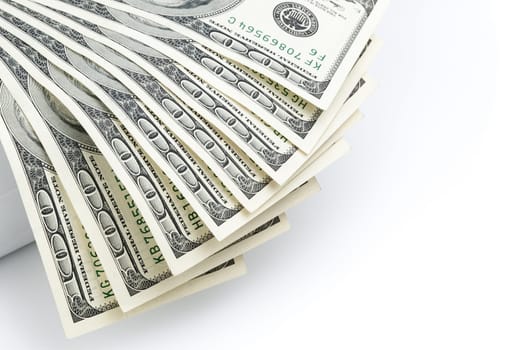 Parts of the bills of one hundred dollars are located on the left with a fan.