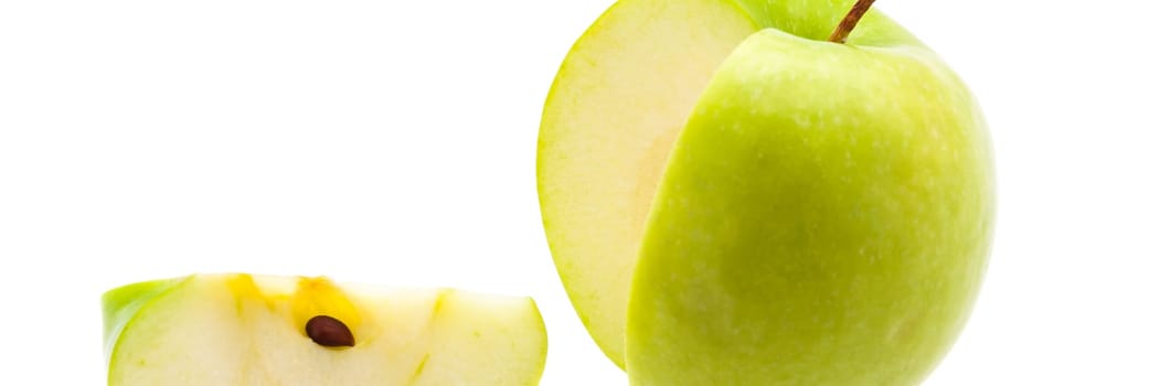 Slice is cut off from a large fresh green apple.