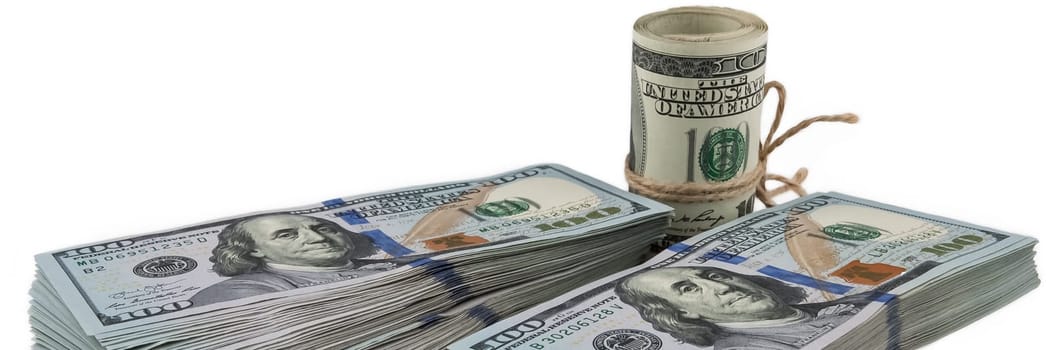 Two packs of one hundred dollar bills and a roll of dollars tied with a rope on a white background. View at an angle. Isolated.