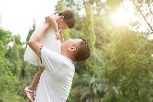 Asian family outdoors portrait. Father and daughter bonding at green park.