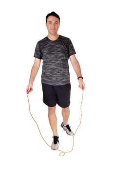 A young man standing in the studio exercising with his rope, in a sports.outfit, isolated for white background.