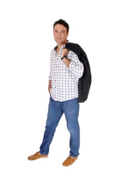 A tall handsome man standing in jeans with his black jacket over his.shoulder, looking into camera, isolated for white background.
