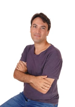 A portrait image of a tall handsome young man sitting on a chair with.his arm crossed, isolated for white background.