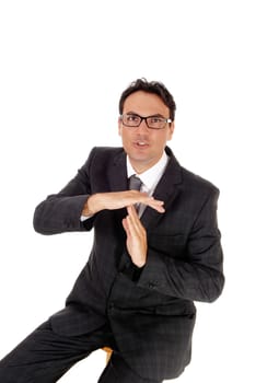 A handsome business man sitting and signing that he likes to talk,.showing with his hands, isolated for white background.
