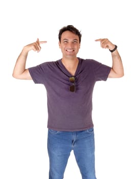 A young very handsome tall man standing in jeans and a t-shirt with.his fingers pointing to his head, isolated for white background.