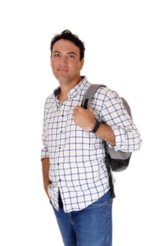 A handsome young man standing in profile looking into the camera.with his backpack on his back, isolated for white background.